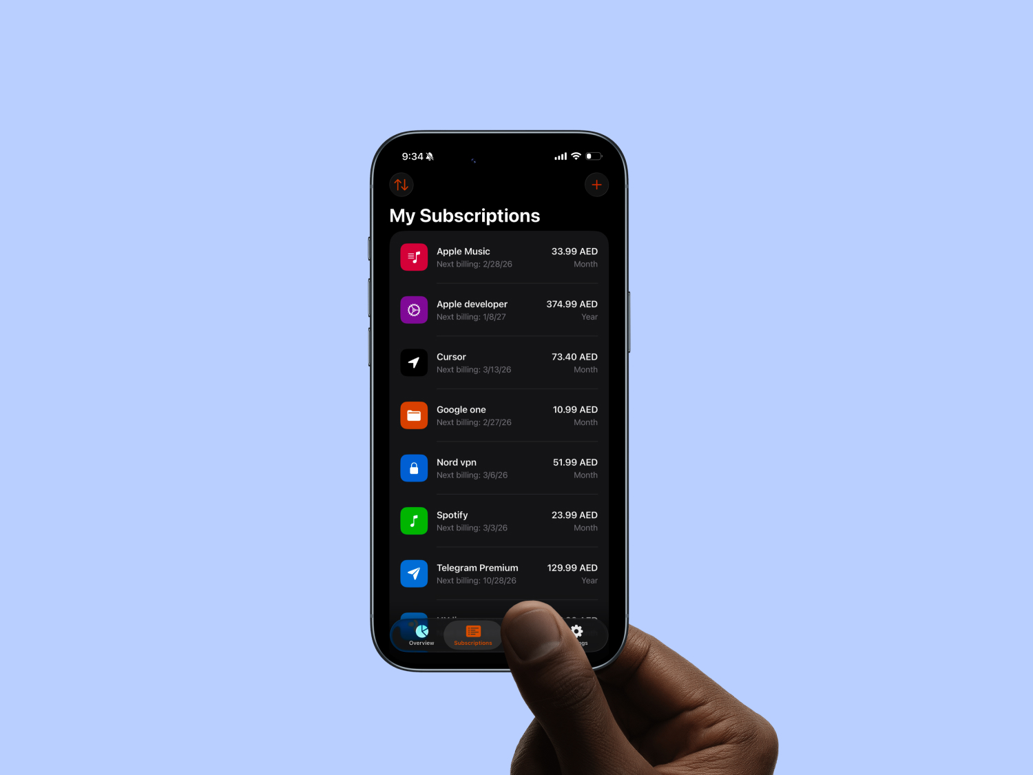 A hand holding an iPhone showing the My Subscriptions list